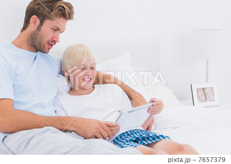 Father and his son using a tablet Father and his son using a tablet 7657379