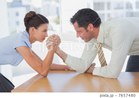 Business people arm wrestling 7657480