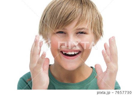 Suprised blonde boy with hands up smiling Suprised blonde boy with hands up smiling 7657730