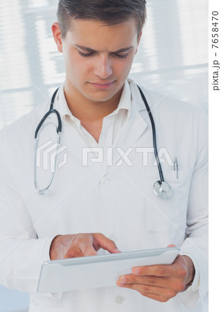 Attractive doctor using digital tablet Attractive doctor using digital tablet 7658470