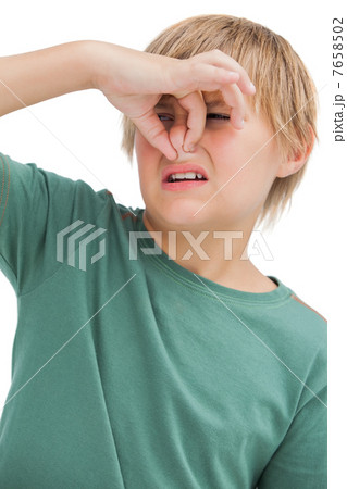 Boy pinching his nose 7658502