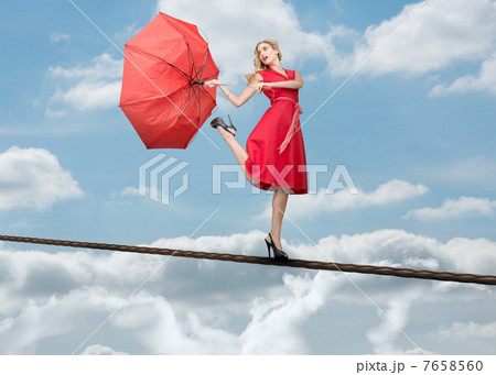 Pretty woman standing over the clouds 7658560