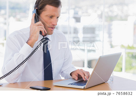 Serious businessman on the phone 7658632