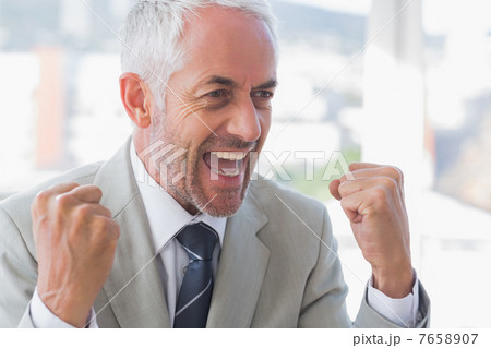 Succesful businessman cheering 7658907