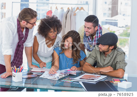 Young designers looking at photos 7658925