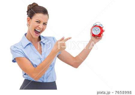 Businesswoman indicating alarm clock 7658998