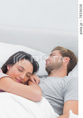 Pretty woman sleeping on her husbands chest 7659036