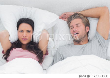 Woman annoyed by the snoring of her husband 7659151