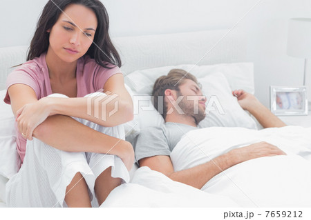 Stressed woman in her bed 7659212