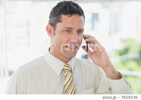 Smiling businessman on the phone 7659336