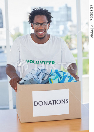 Happy man holding donation box 7659357