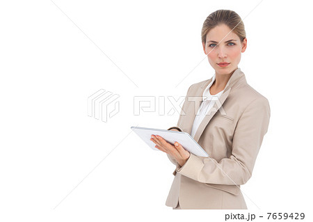 Serious businesswoman holding digital tablet 7659429