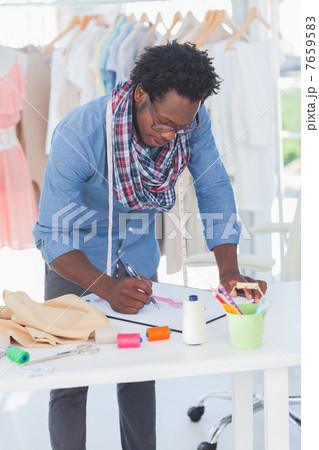 Attractive fashion designer drawing Attractive fashion designer drawing 7659583