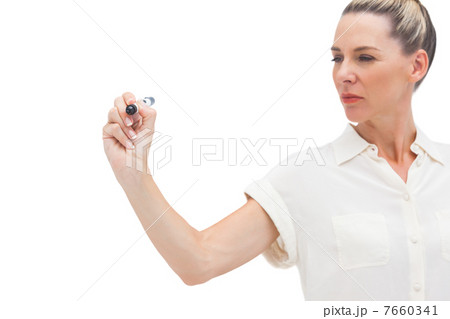 Serious businesswoman looking at pen in her hand 7660341