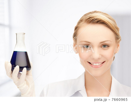 female chemist holding bulb with chemicals 7660965