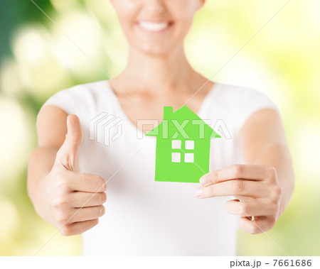 woman hands holding green house 7661686