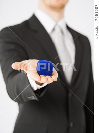 man with gift box in suit man with gift box in suit 7661687