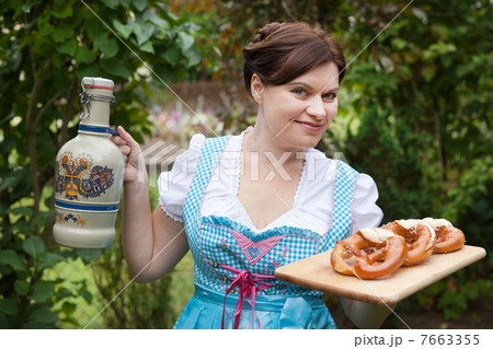 Happy beautiful woman in dirndl dress holding Oktoberfest beer a Happy beautiful woman in dirndl dress holding Oktoberfest beer a 7663355