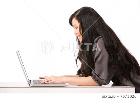 Happy Asian woman using her laptop. Happy Asian woman using her laptop. 7673026