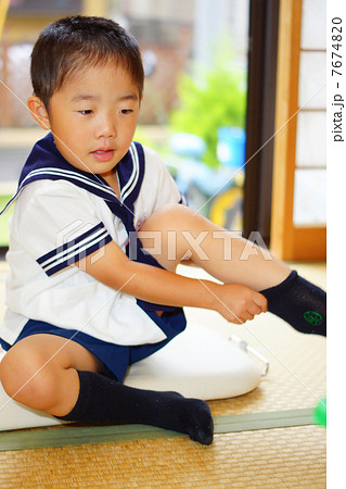 A Boy Changing Clothes To Kindergarts Alone Stock Photo