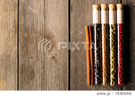 Spices in beakers on wooden table Spices in beakers on wooden table 7680066