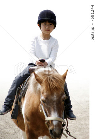 乗馬する男の子 7691244