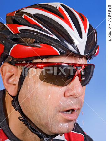 sweaty cyclist on a blue background 7694998