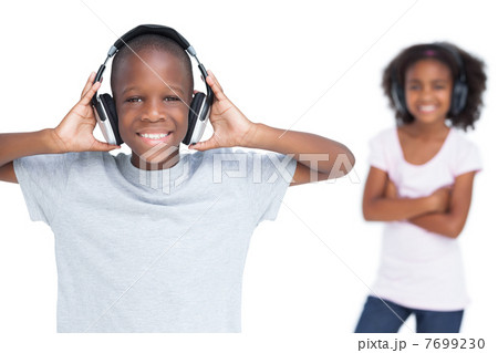 Brother and sister listening to music Brother and sister listening to music 7699230