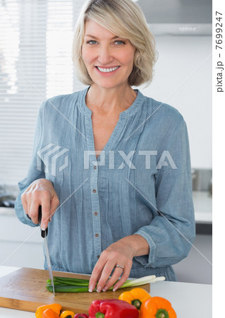 Happy woman preparing vegetables 7699247