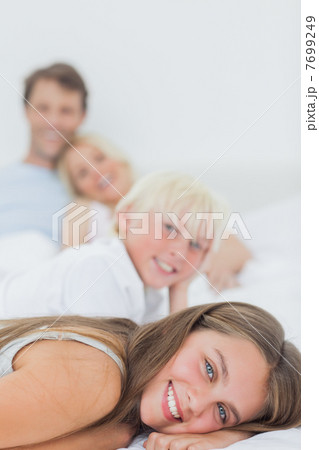 Smiling siblings lying on the bed 7699249