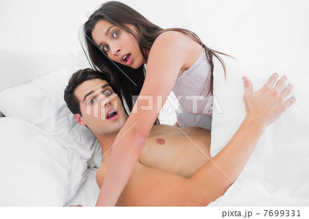 Beautiful couple surprised in bed 7699331