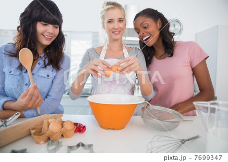 Happy friends making pastry together Happy friends making pastry together 7699347
