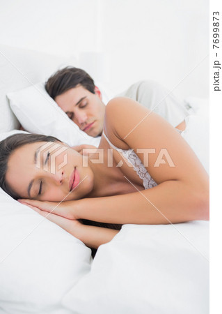 Woman sleeping next to her partner 7699873
