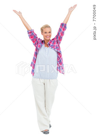 Blonde woman standing with hands up in air Blonde woman standing with hands up in air 7700049