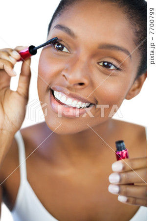 Happy woman using mascara for her eyelashes Happy woman using mascara for her eyelashes 7700799