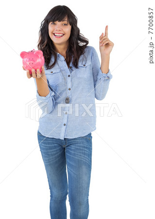 Smiling young woman with piggy bank pointing her finger Smiling young woman with piggy bank pointing her finger 7700857