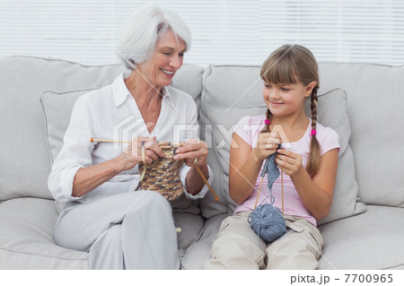 Granddaughter learning how to knit with grandmother Granddaughter learning how to knit with grandmother 7700965