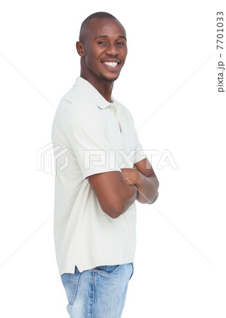 Smiling young man standing with arms crossed 7701033