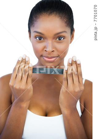 Happy woman holding nail file 7701070