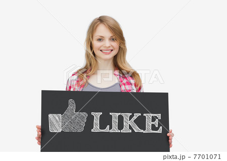 Smiling girl holding panel with thumb up representing social net 7701071
