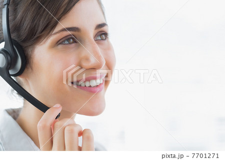 Brunette call centre agent smiling 7701271