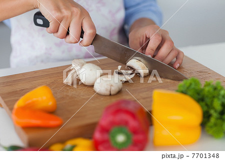 Woman slicing mushrooms 7701348