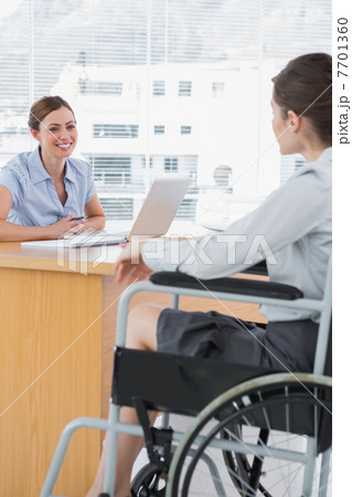 Businesswoman interviewing disabled job candidate Businesswoman interviewing disabled job candidate 7701360