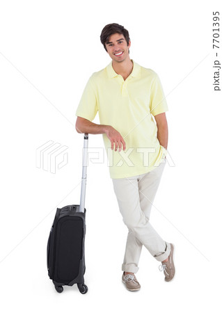 Smiling man standing with his suitcase Smiling man standing with his suitcase 7701395
