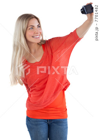 Smiling woman taking picture of herself Smiling woman taking picture of herself 7701482