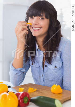 Pretty brunette holding piece of pepper 7701616