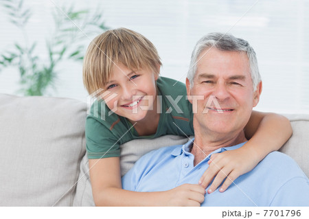 Portrait of grandson embracing grandfather 7701796