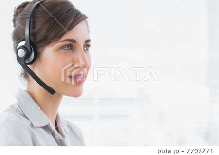 Pretty call centre agent smiling 7702271