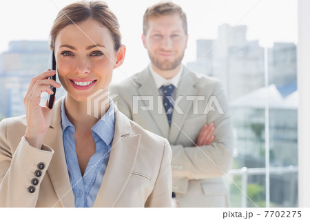 Smiling businesswoman having phone conversation 7702275