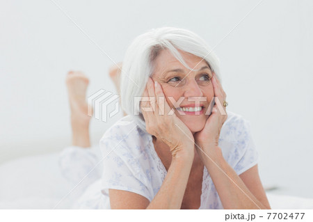 Woman lying on bed 7702477